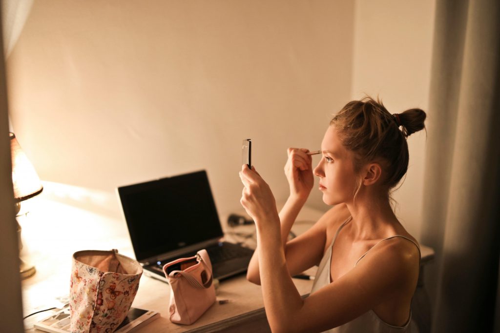 woman applying makeup scaled